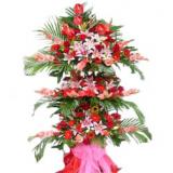 花篮:19枝红玫瑰,绿叶间插，卷边纸圆形精美包装,淡绿色丝带